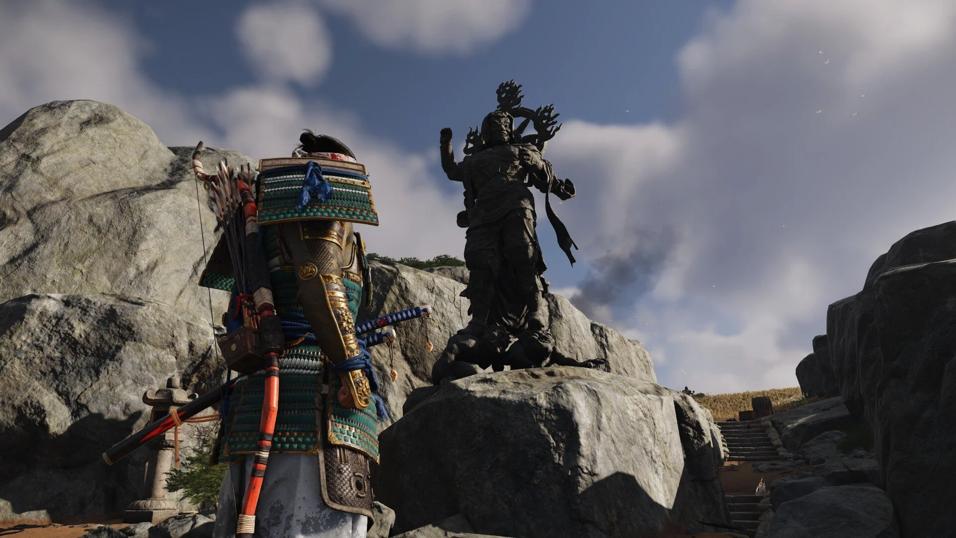 Standing looking at statue on cliff area